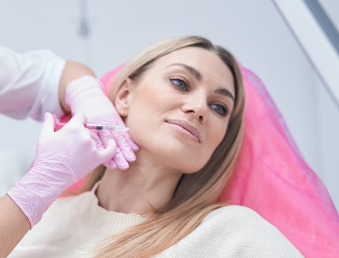 Dermatologist in nitrile gloves conducting mesotherapy procedure
