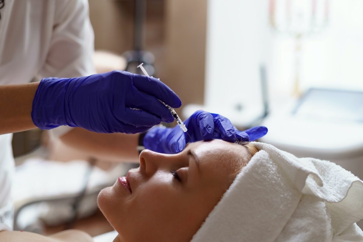 Close-up of a smiling woman receiving a Botox injection at Swann Skincare & Aesthetics, a trusted provider of Botox treatments in Glasgow. Close-up of a smiling woman receiving a Botox injection at Swann Skincare & Aesthetics, a trusted provider of Botox treatments in Glasgow.